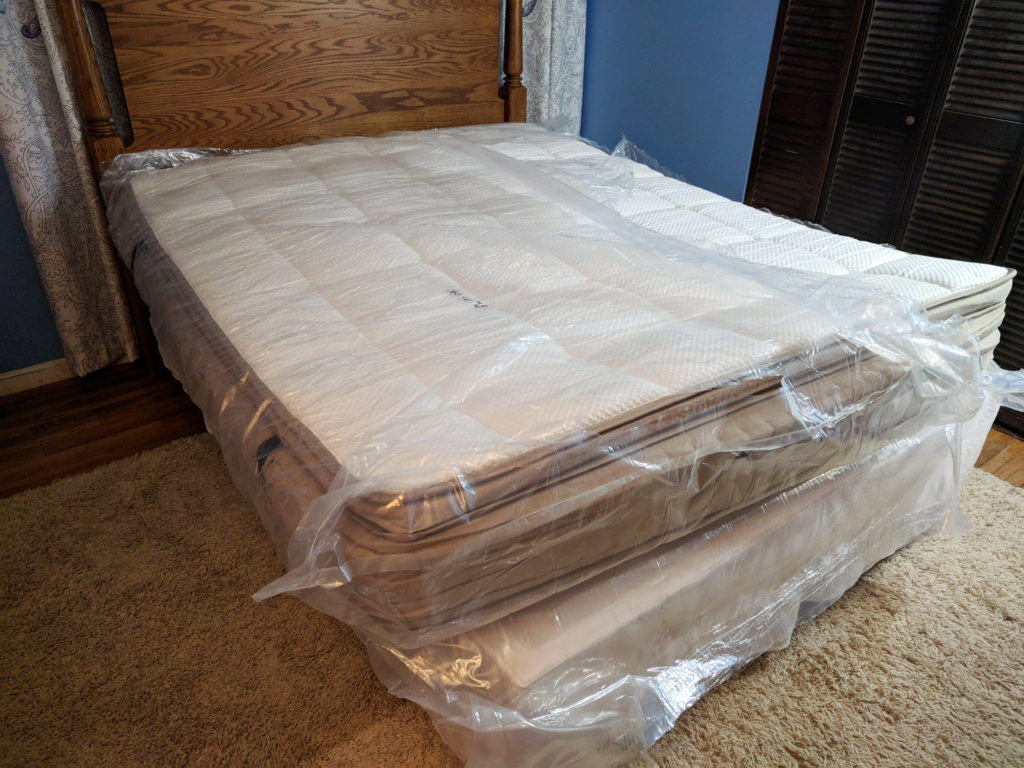 dreamcloud mattress unfolded in plastic
